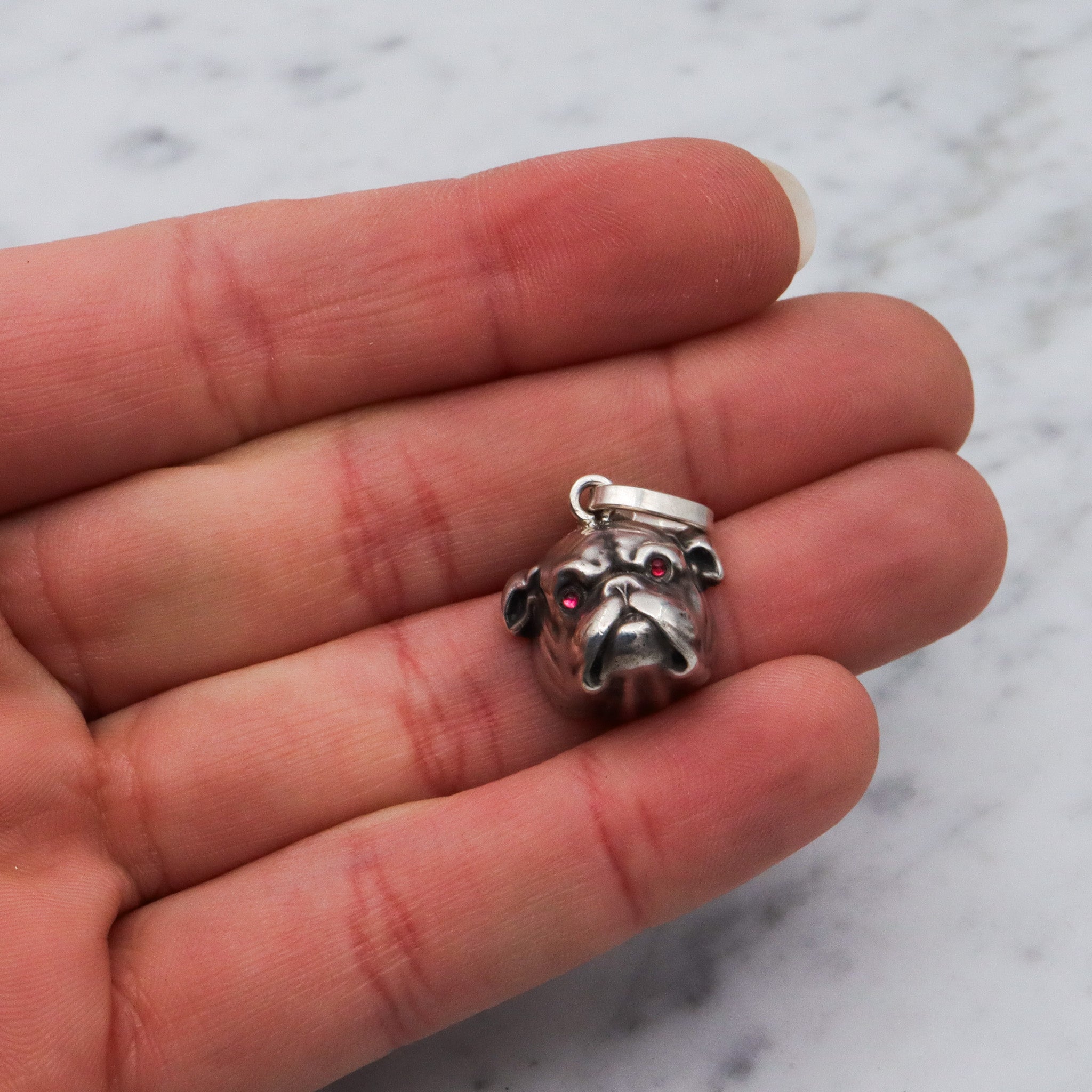 Antique Unger Brothers sterling silver bulldog with ruby glass eyes pendant